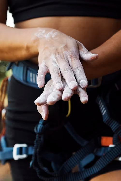 hands of a women climber with chalk